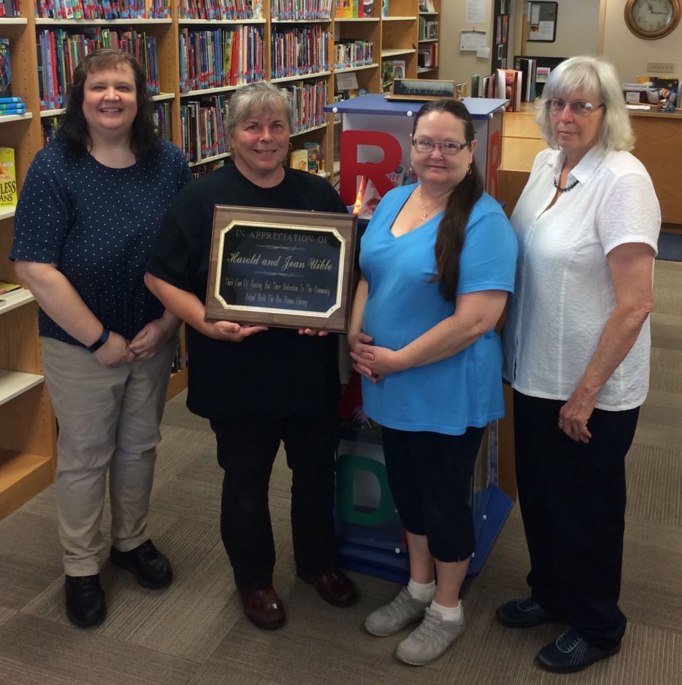 group holding plaque